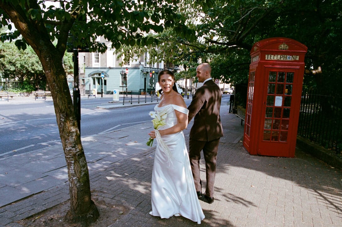 Islington Town Hall wedding couple walking to Routemaster bus in Clerkenwell, documentary London wedding photography by Nick Tucker