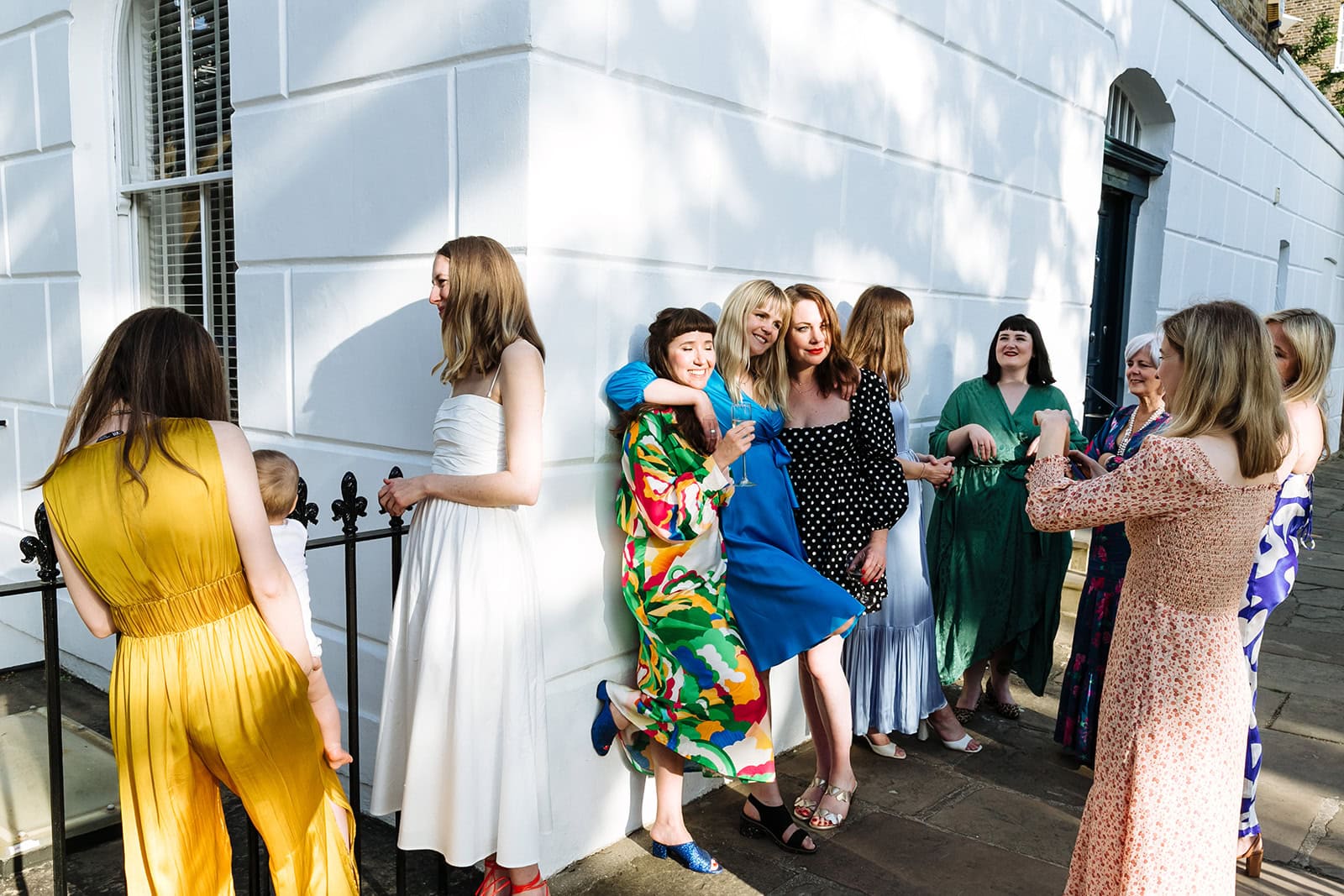A group of women dance outside in colourful dresses