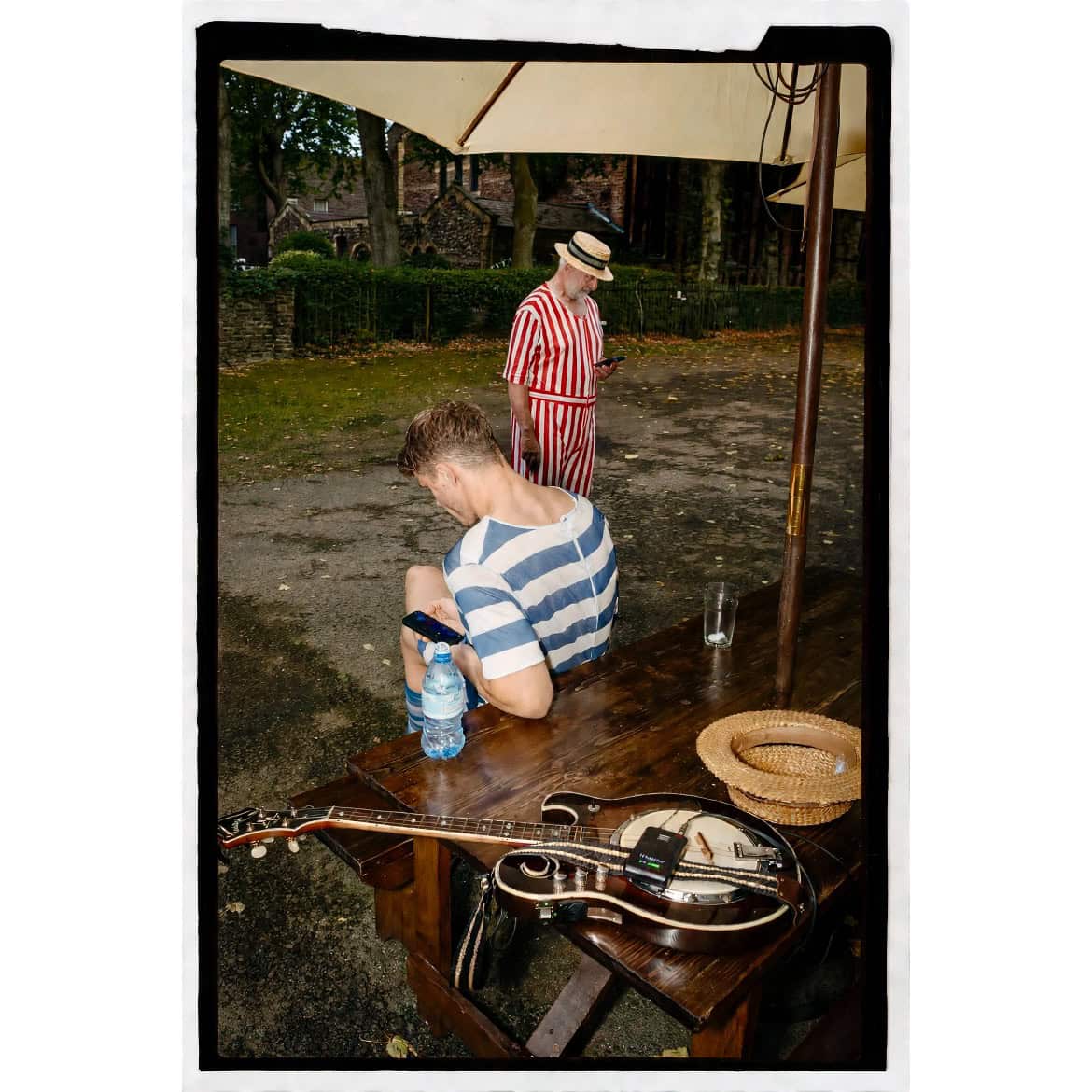 A small child stands under a garden canopy