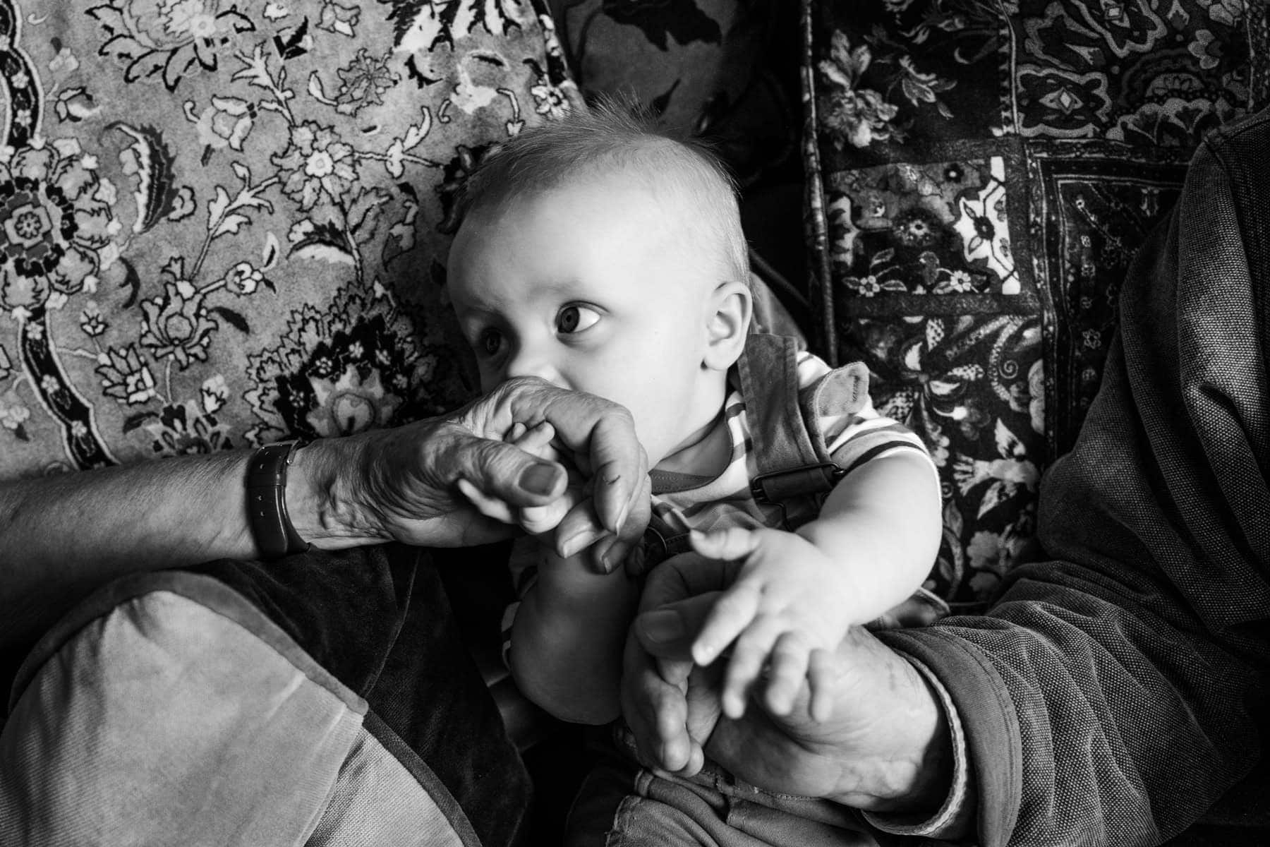 A baby looks directly at the camera in a close black-and-white photograph