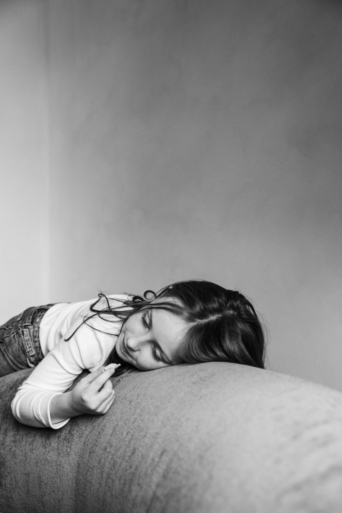 A child sleeps with their head on a cushion