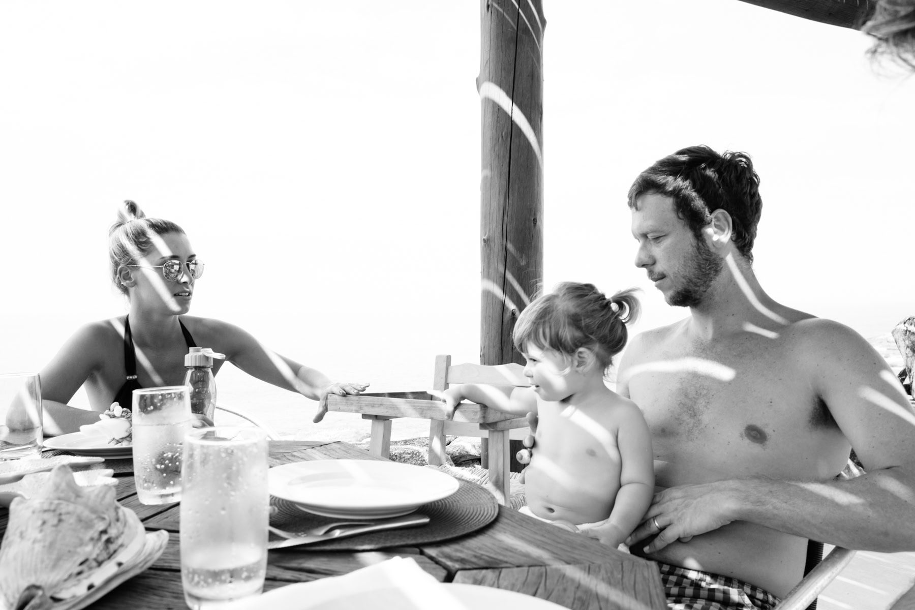 A family talks around a table in black and white