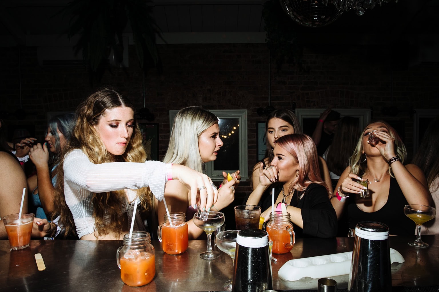 Friends pour drinks around a table
