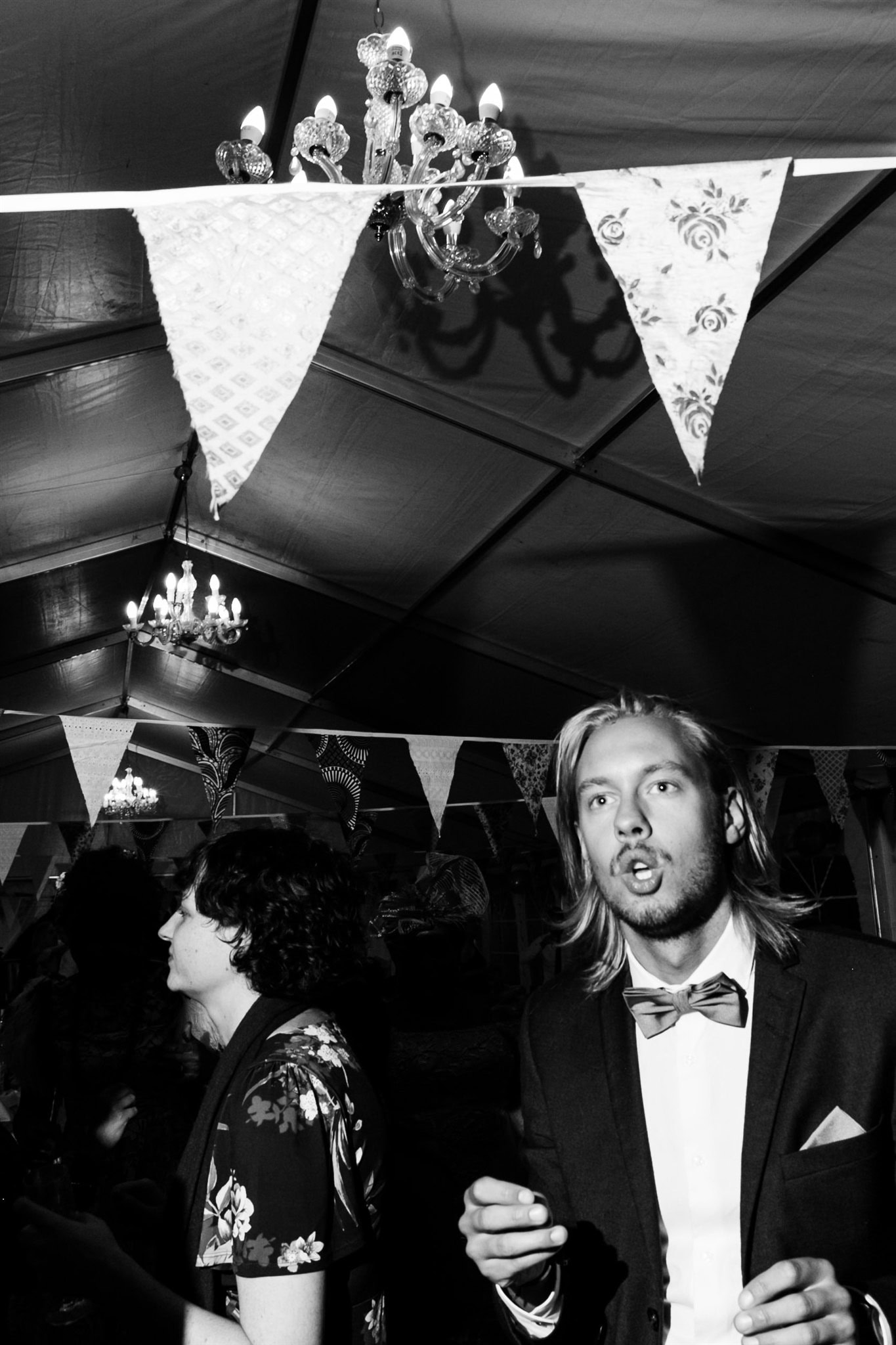 A surprised guest looks up beneath party bunting