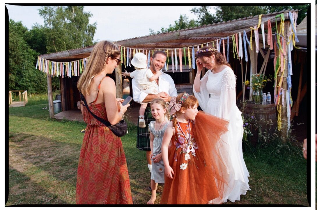 Zoe with children and guests outside the wooden bar