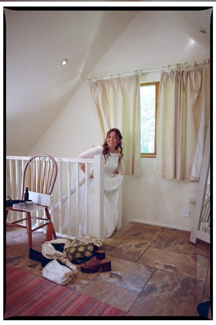 Zoe in her wedding dress beside the staircase