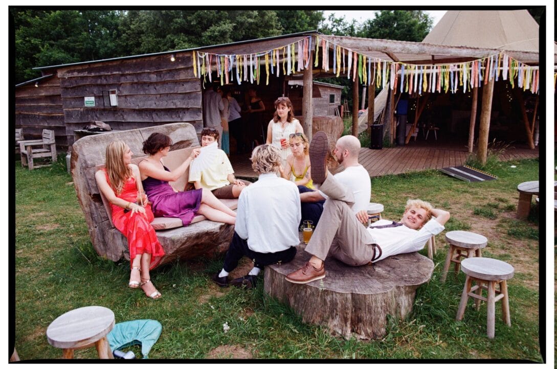 Guests relaxing around rustic wooden seating