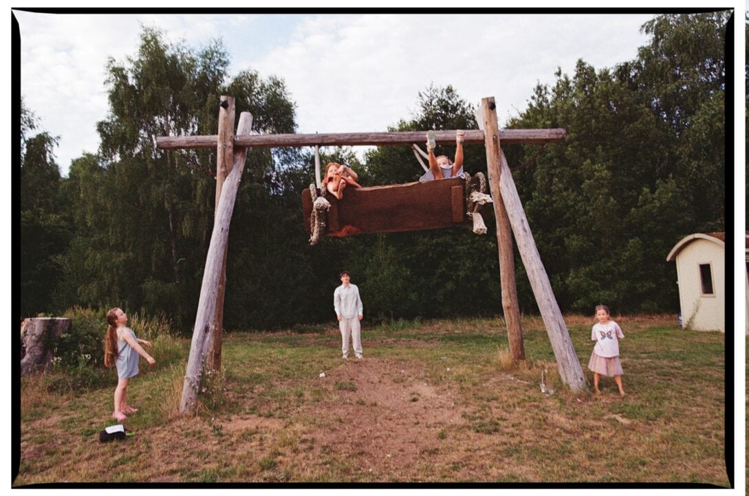 Children flying high on the giant woodland swing