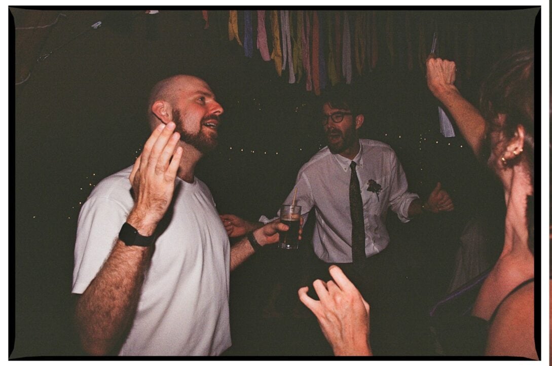 Oliver dancing with guests in the dark reception tent