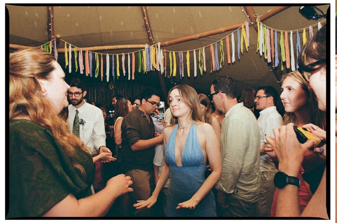 Guests dancing together inside the Wellington Wood tent
