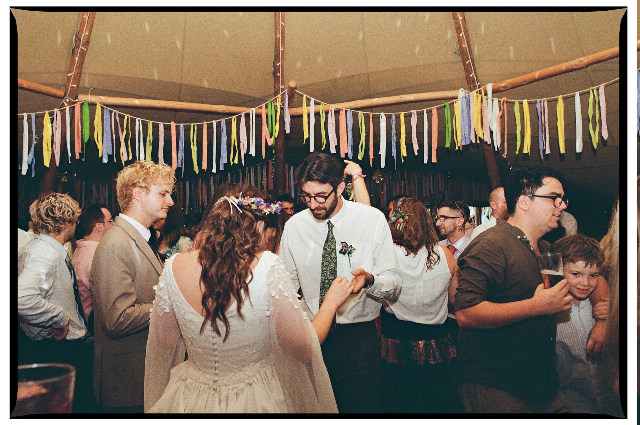 Oliver and Zoe dancing among their wedding guests