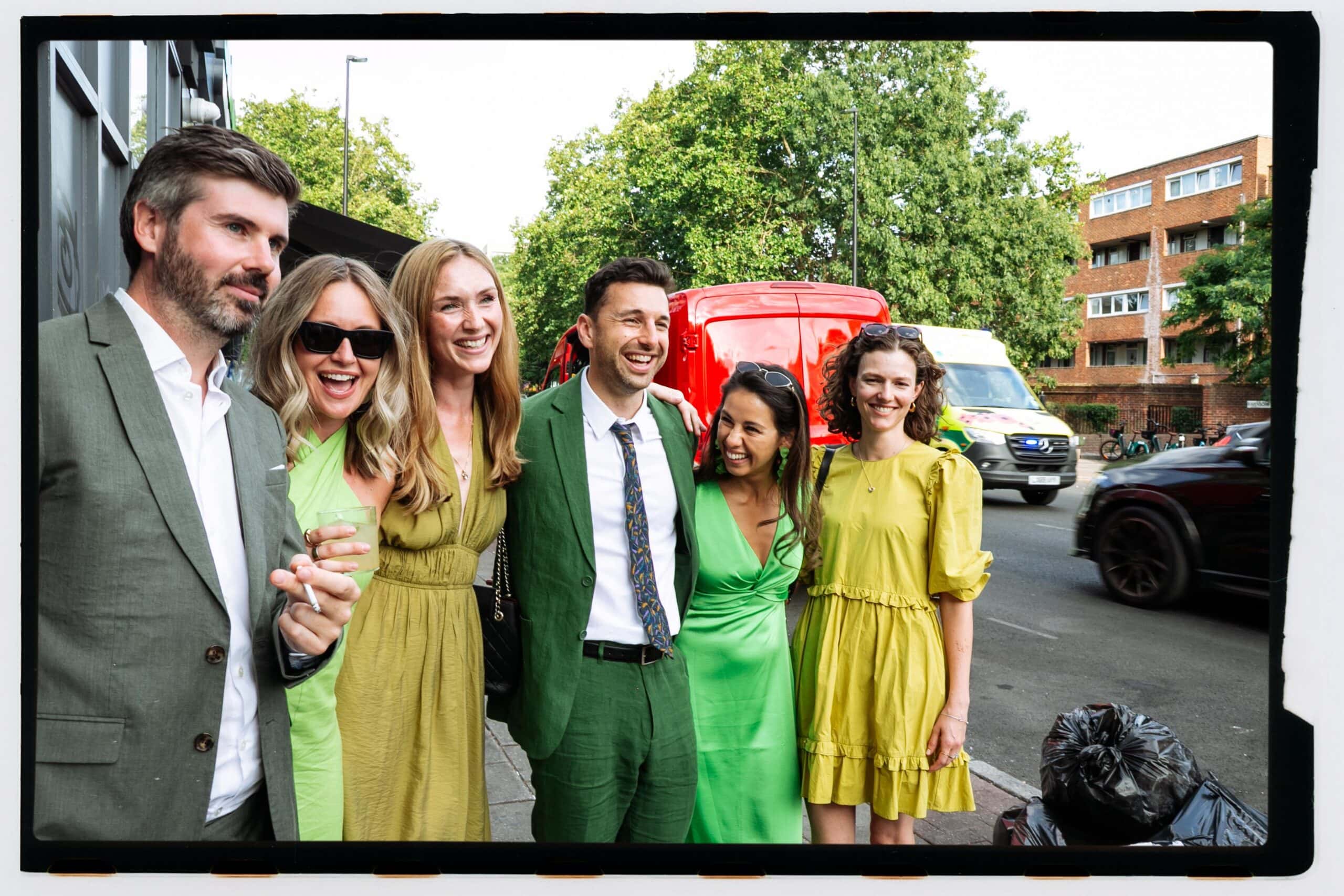 Guests pose together on a London pavement