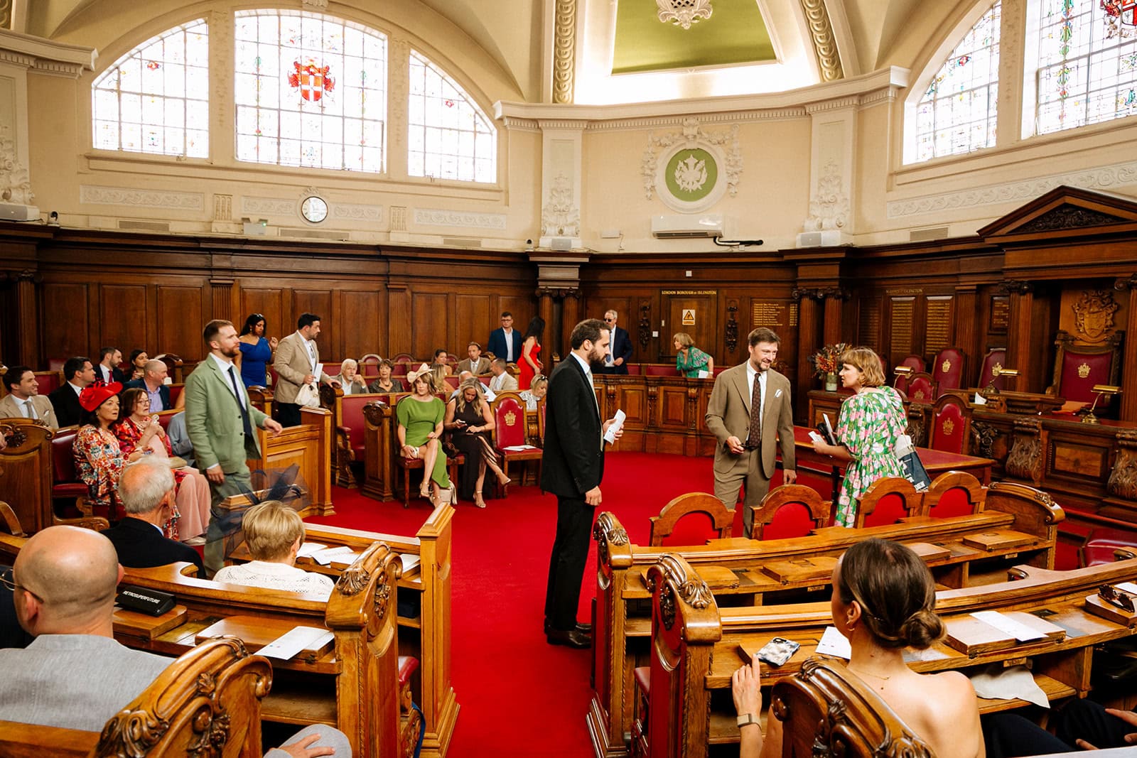 Wedding guests seated around the Council Chamber’s horseshoe seating