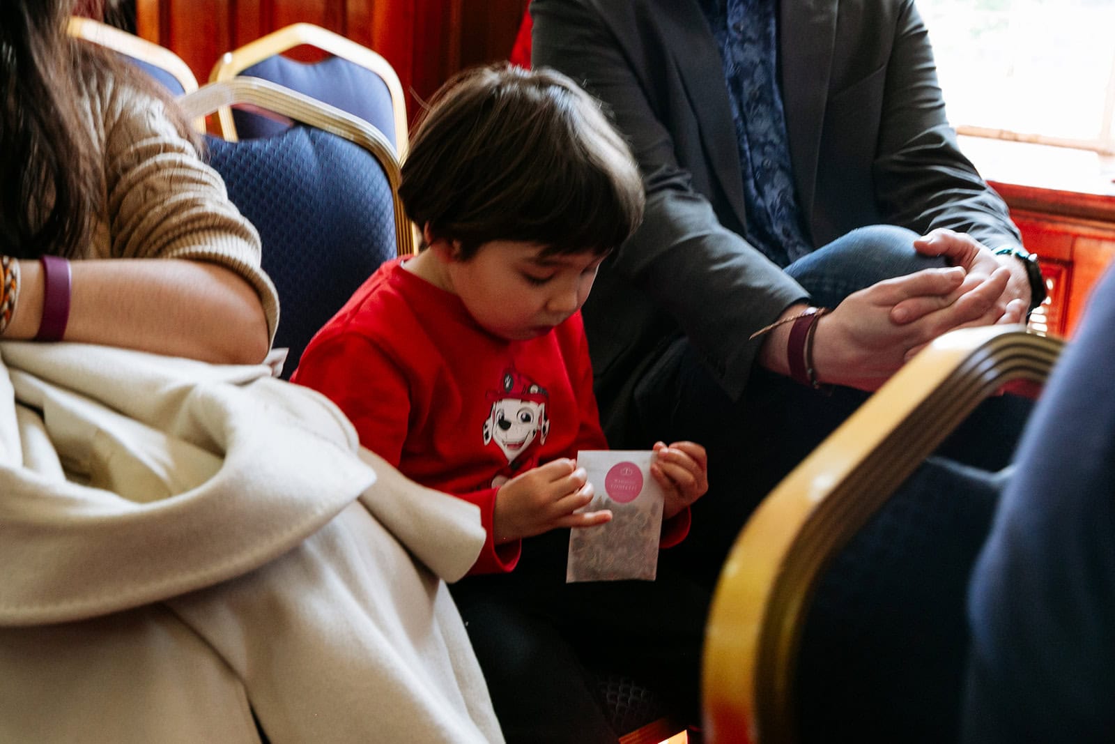A child in a red shirt plays before the wedding ceremony
