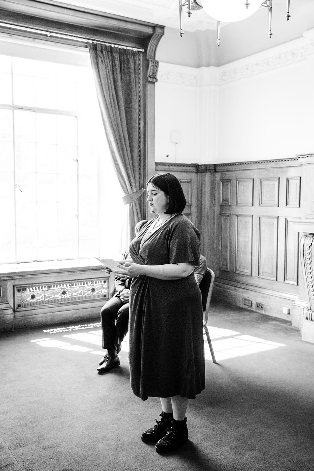 A guest beside a window in the Richmond Suite