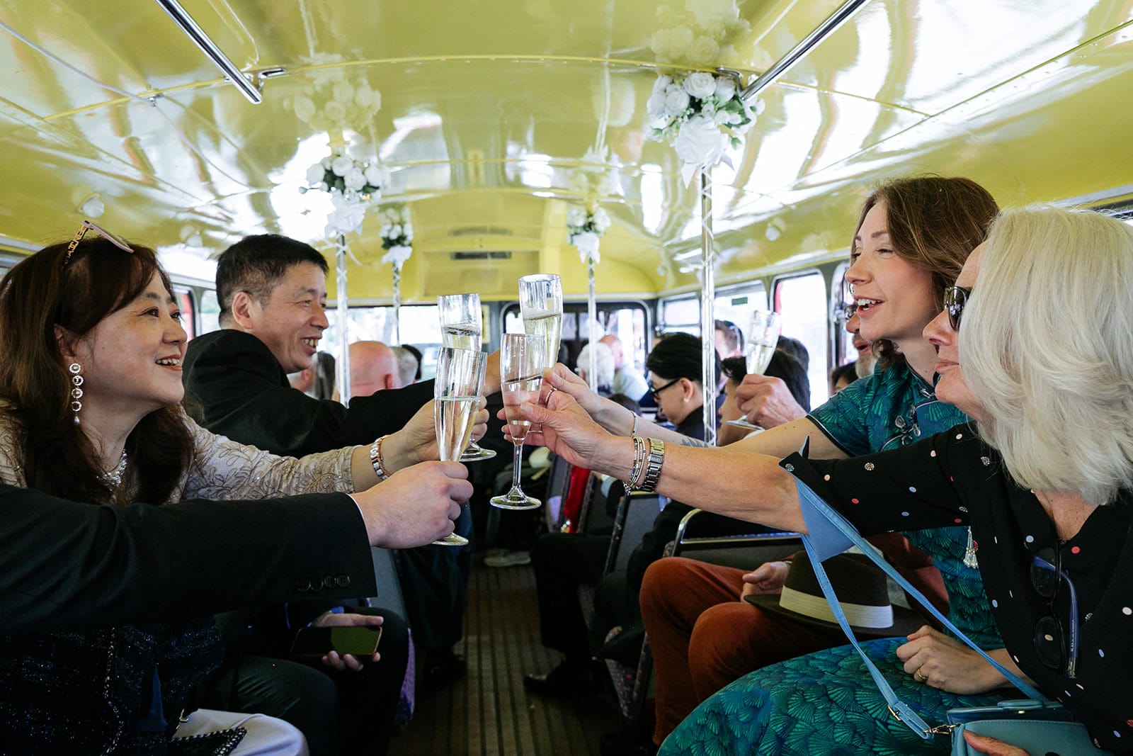A champagne toast aboard the wedding bus