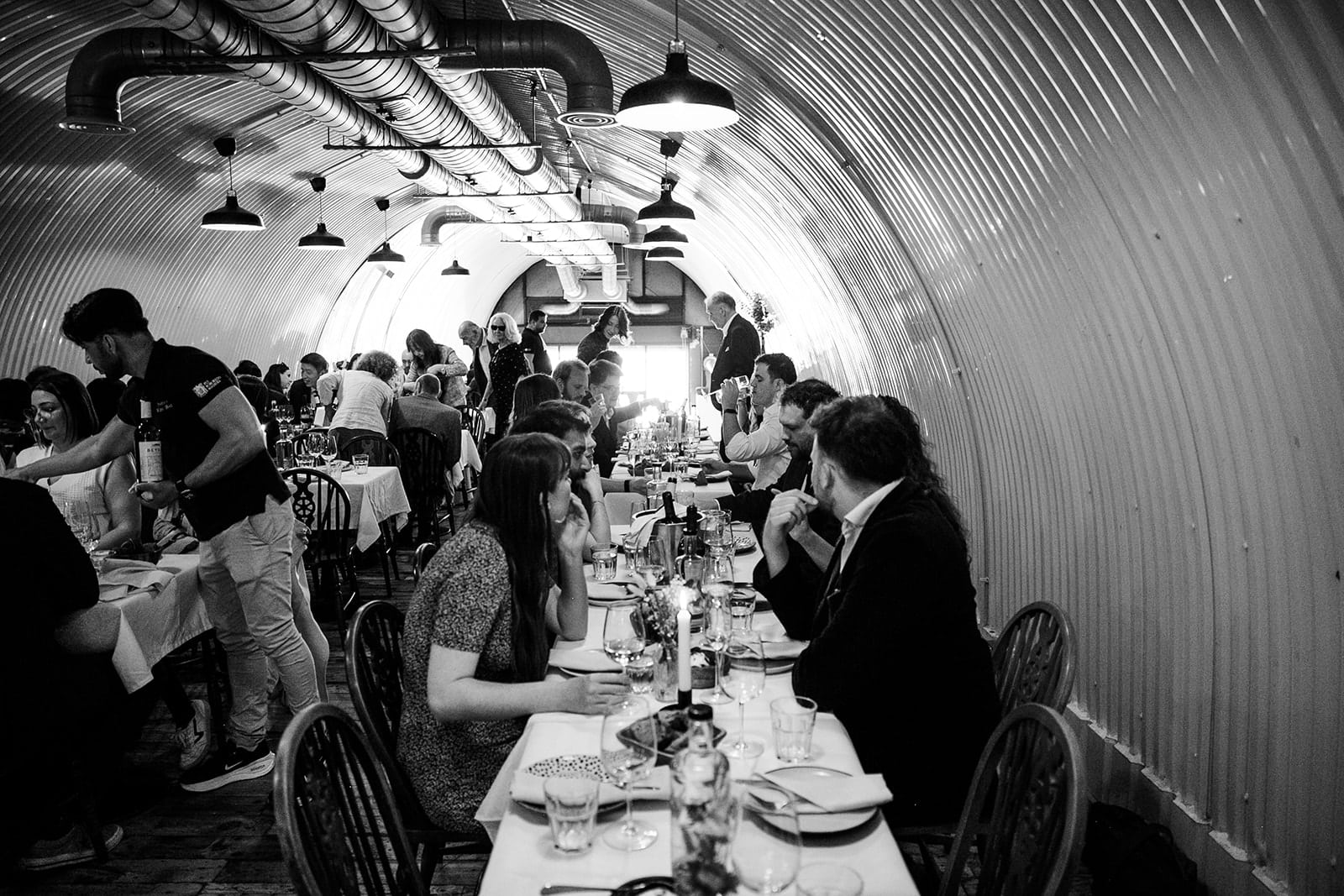Wedding guests dine beneath the brick arches at Pedro’s Wine Bar in Bermondsey