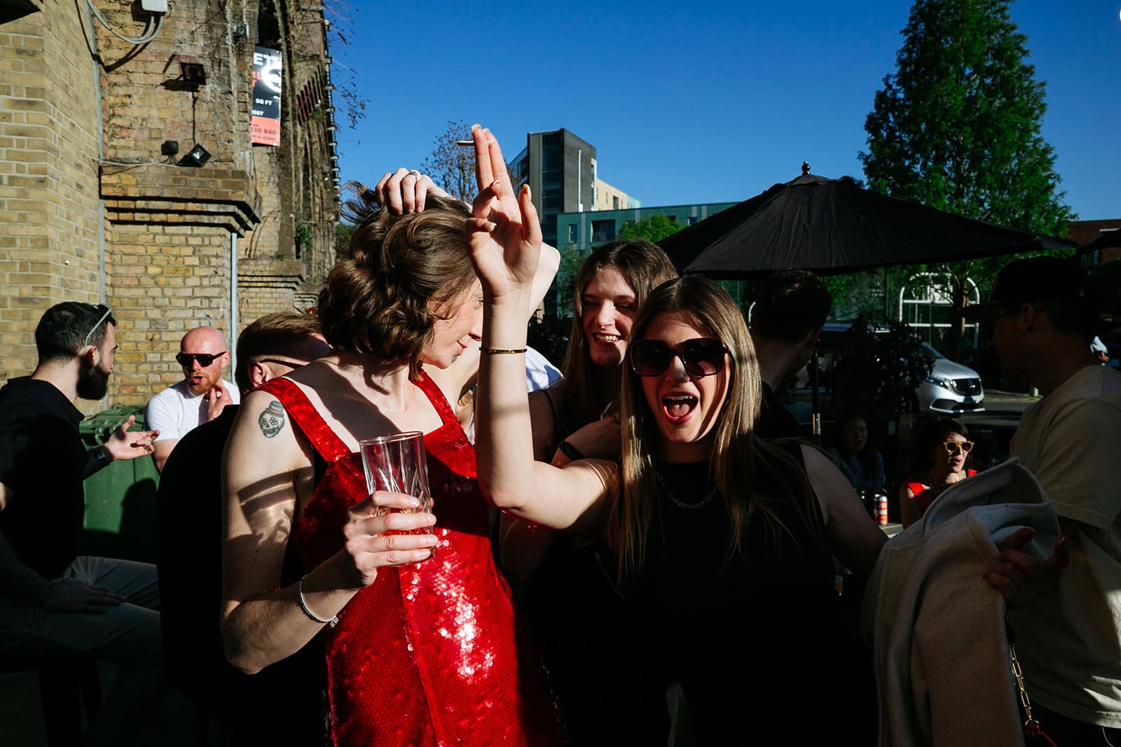Ruby and a guest laugh and gesture outside Pedro’s Wine Bar