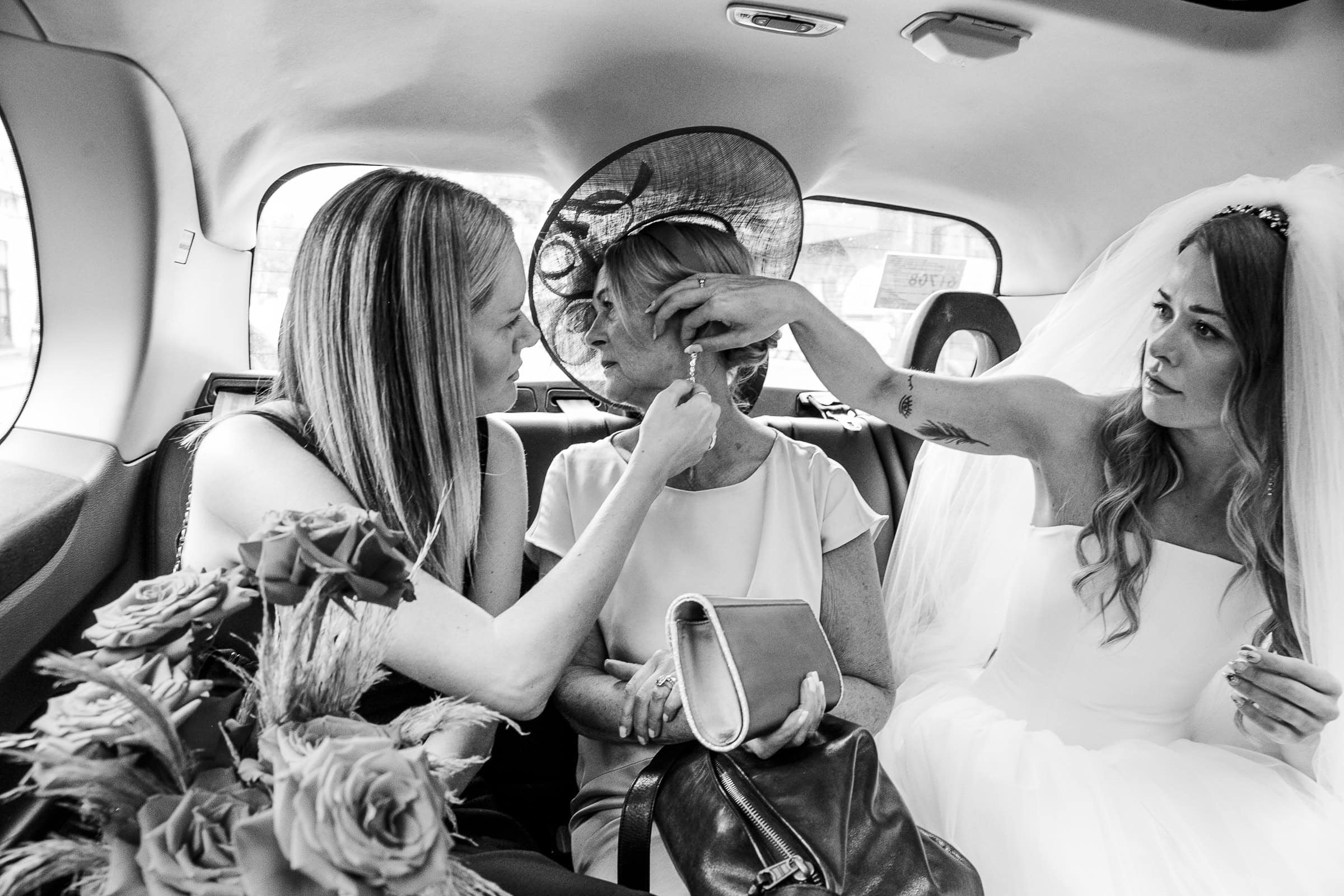 Kate and two companions sharing a moment in the taxi