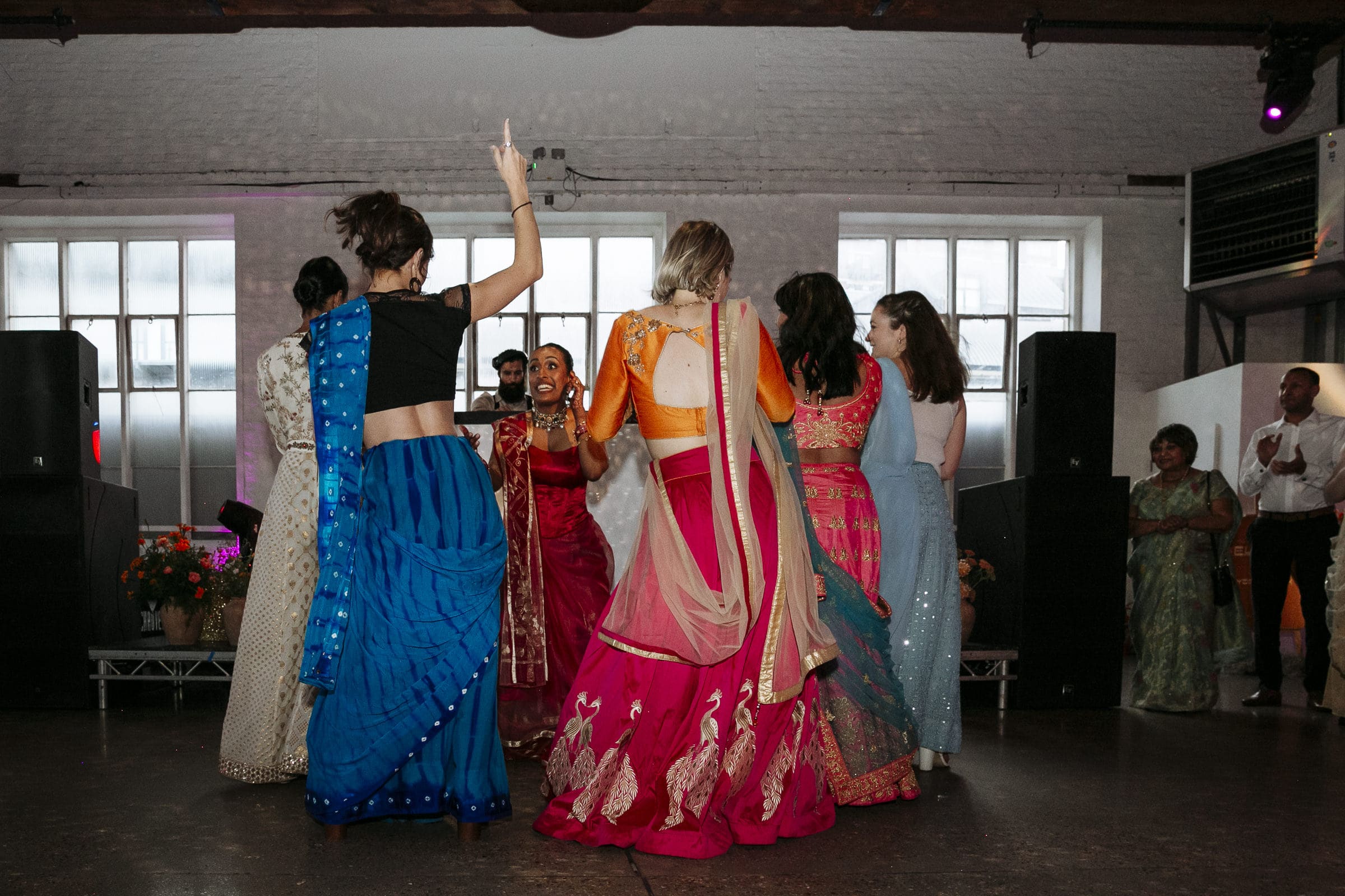 Wedding guests dancing together in the reception room