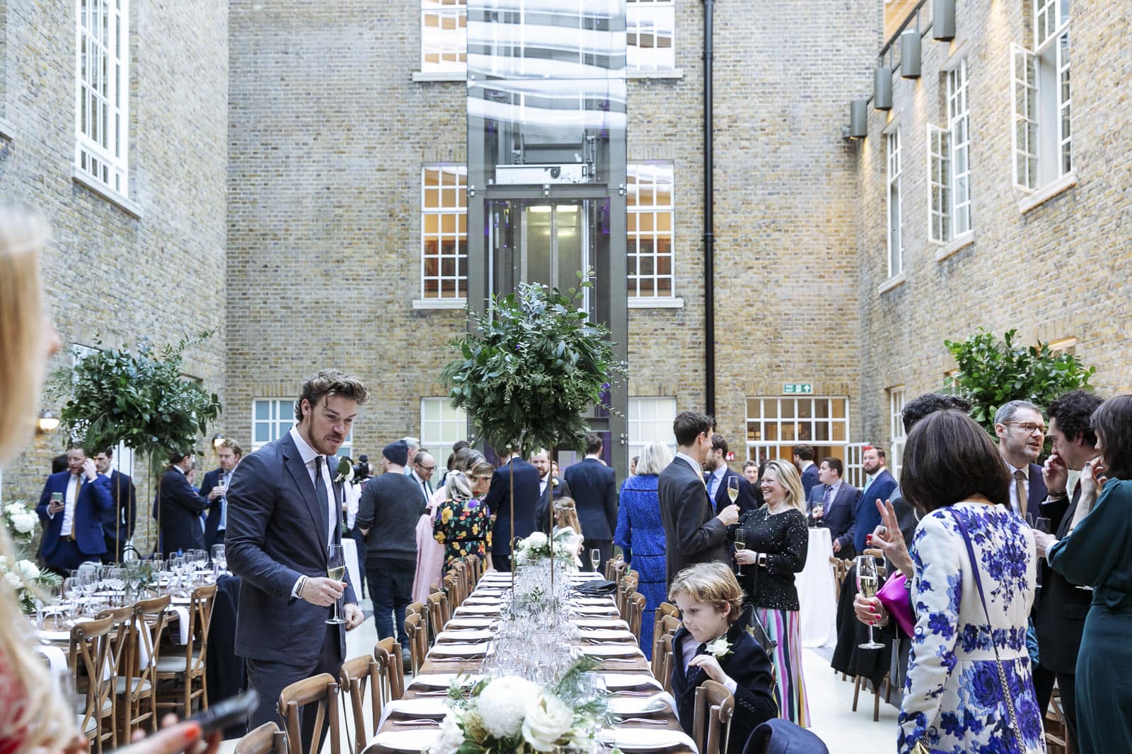 Guests gathering around the reception tables in the North Atrium
