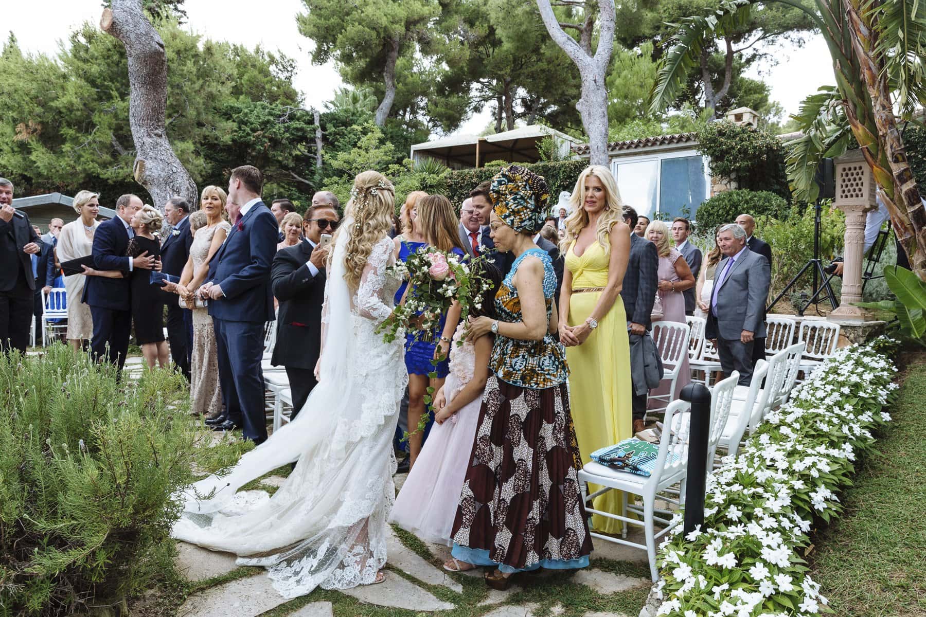 Roisin in her wedding dress among guests on the garden terrace